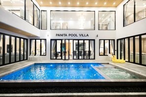 A pool area with a sign reading 'PANITA POOL VILLA.' - Panita Poolvilla (Photharam)