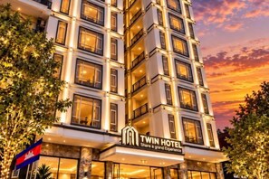 A multi-story hotel with a prominent sign reading 'Twin Hotel.' - Twin Hotel Kampot (Kampot)