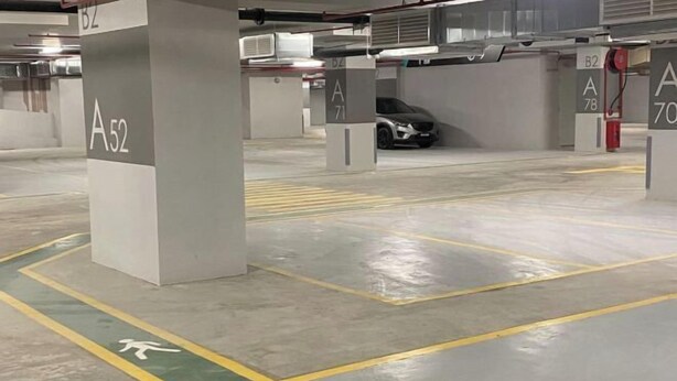 A parking garage with clearly marked parking spaces labeled A52, A71, B2, and B78. - KL Sentral 28th Floor CityCenter (Kuala Lumpur)