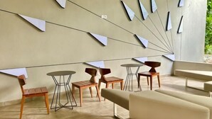 A modern interior with a sofa, tables, and chairs arranged for seating. - KL Sentral 28th Floor CityCenter (Kuala Lumpur)