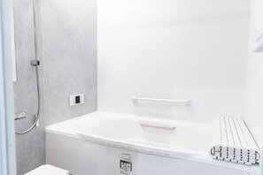 A modern bathroom with a shower, a toilet, and a built-in heater. - Mirai Stay Yokote (Kumamoto)