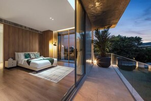A modern bedroom with a large bed, a nightstand, and a glass balcony overlooking a cityscape. - Xman Xinggong 6 +1 Bed 5 Bath Pool Villa Privacy and Freedom Coexist (Bangkok)