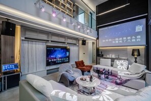 A modern living room with a flat-screen TV, comfortable seating, and a coffee table. - Xman Xinggong 6 +1 Bed 5 Bath Pool Villa Privacy and Freedom Coexist (Bangkok)