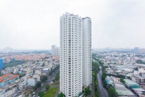 A high-rise building with a modern architectural design, surrounded by a cityscape. - Sunrise City Lotte D7 (Ho Chi Minh City)