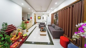 A hotel lobby with a reception desk, seating area, and decorative plants. - Lam Anh Hotel 2 Duong Noi Ha Dong (Hanoi)