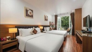 A hotel room with two beds, a TV, a desk, and a balcony with a view. - Lam Anh Hotel 2 Duong Noi Ha Dong (Hanoi)