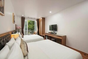 A hotel room with two beds, a TV, a desk, and a window with a view of greenery. - Lam Anh Hotel 2 Duong Noi Ha Dong (Hanoi)