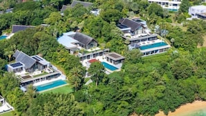 A luxury resort with multiple villas, each featuring a private pool and surrounded by lush greenery. - 6BR Oceanfront Luxury Villa 30m Infinity Pool Villa Serenity Warm Plus (Phuket)