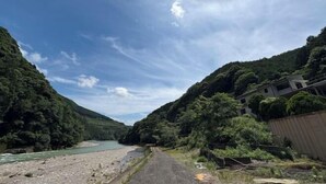 A river with a narrow path beside it, surrounded by lush greenery and hills. - SEN.RETREAT TAKIJIRI (Tanabe)