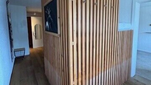 A room with a wooden partition wall, a framed picture, and a door. - Outside: Bright and warm apartment, facing south, with furnished terrace and exceptional view of the (St-Luc)
