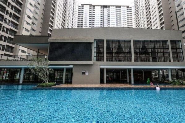 A swimming pool with a building in the background.