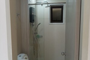 A shower area with a glass door, a small window, and a towel rack. - Nilai Youth City Residence C-25-15 (Nilai)