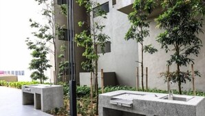 A modern outdoor area with concrete planters and a water feature.