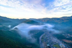 A mountainous landscape with a valley and a town below. - SEN.RETREAT TAKAHARA (Tanabe)