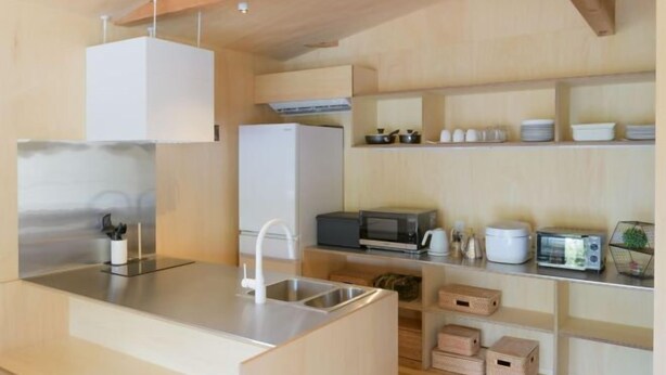 A modern kitchen with a central island, built-in appliances, and ample storage. - SEN.RETREAT TAKAHARA (Tanabe)