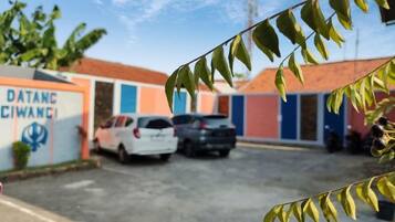 A parking area with a building labeled 'DATANG CIWANGI' and a clear sky.