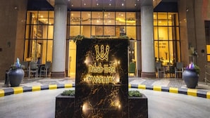 The exterior of the Dabab Hotel by Warwick with a prominent entrance and a decorative sign in front. - Dancenter Al Dabab Near King Fahad Medical City (Riyadh)