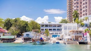 A coastal hotel with a pool, a beach, and a view of the ocean. - The Mark Resort Cebu (Lapu-Lapu City)