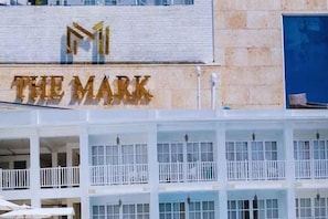A hotel with a prominent sign reading 'THE MARK' and a multi-story structure with balconies. - The Mark Resort Cebu (Lapu-Lapu City)
