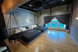 A modern room with a hanging chair, two beds, a large window, and a view of greenery. - 1Medini Hub near Legoland By Ucome Homestay (Iskandar Puteri)