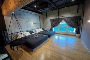 A modern room with a hanging chair, two beds, a large window, and a view of the outdoors. - 1Medini Hub near Legoland By Ucome Homestay (Iskandar Puteri)