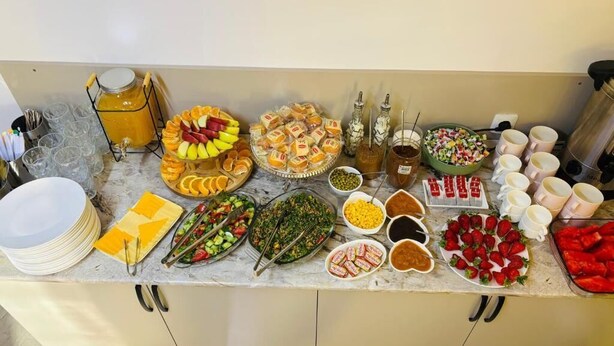 A buffet setup with various food items and condiments. - Styopa Hotel (Yerevan)