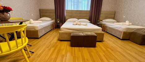 Family Triple Room, Courtyard View | Desk, laptop workspace, soundproofing, iron/ironing board