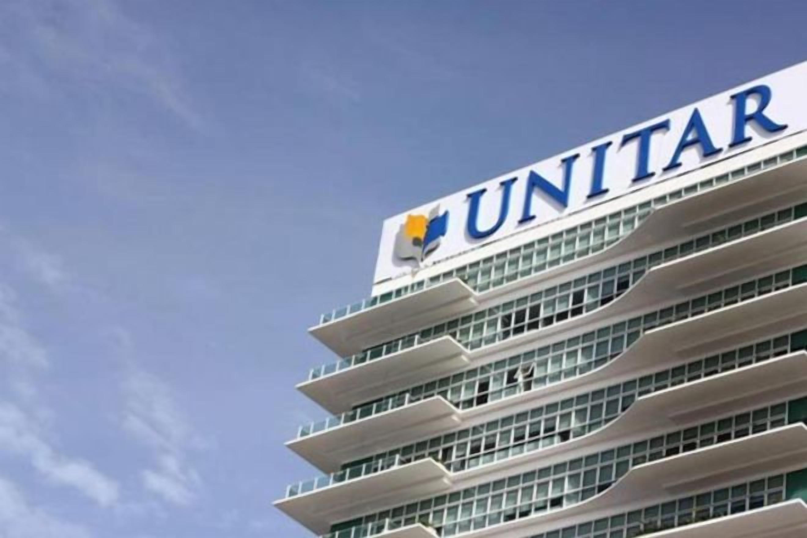 A multi-story building with the UNITAR logo on the top.