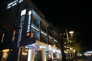 A building with signs for Korean BBQ, Italian, and Pizza-Pasta.