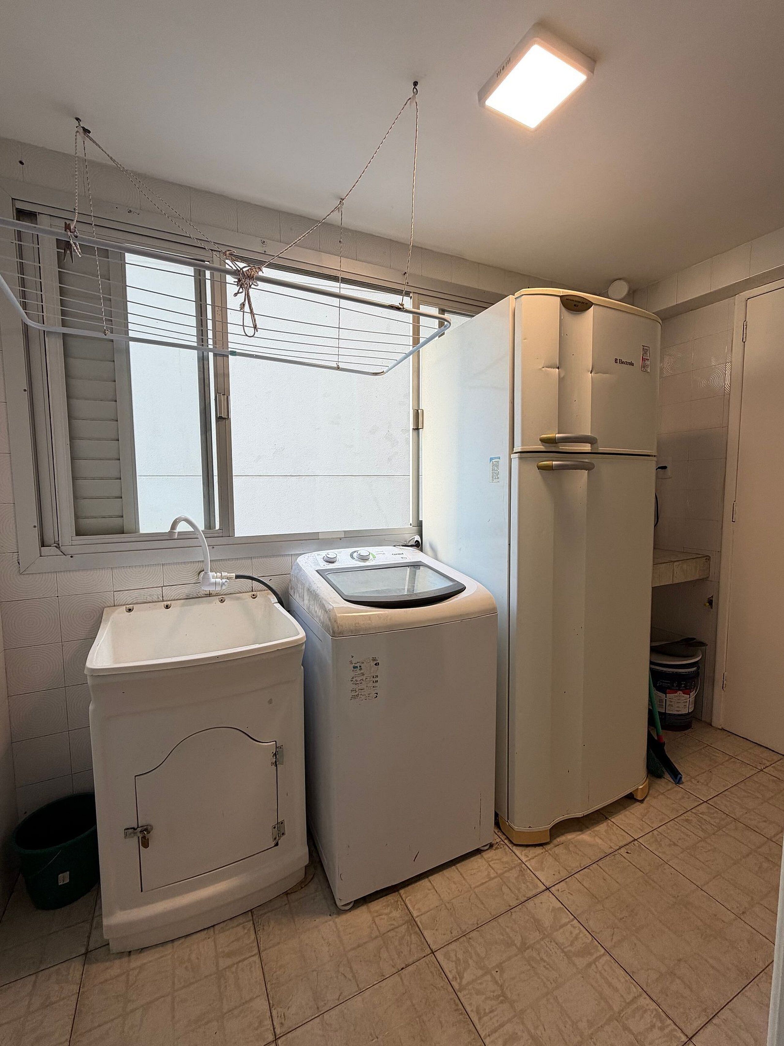 A laundry area with a washing machine, dryer, and a small sink.