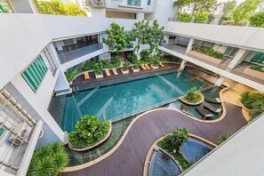 A modern indoor swimming pool with multiple levels and surrounding greenery. - Mulberry Verve Suites KL Mid Valley 4Pax 2 Bedroom (Kuala Lumpur)
