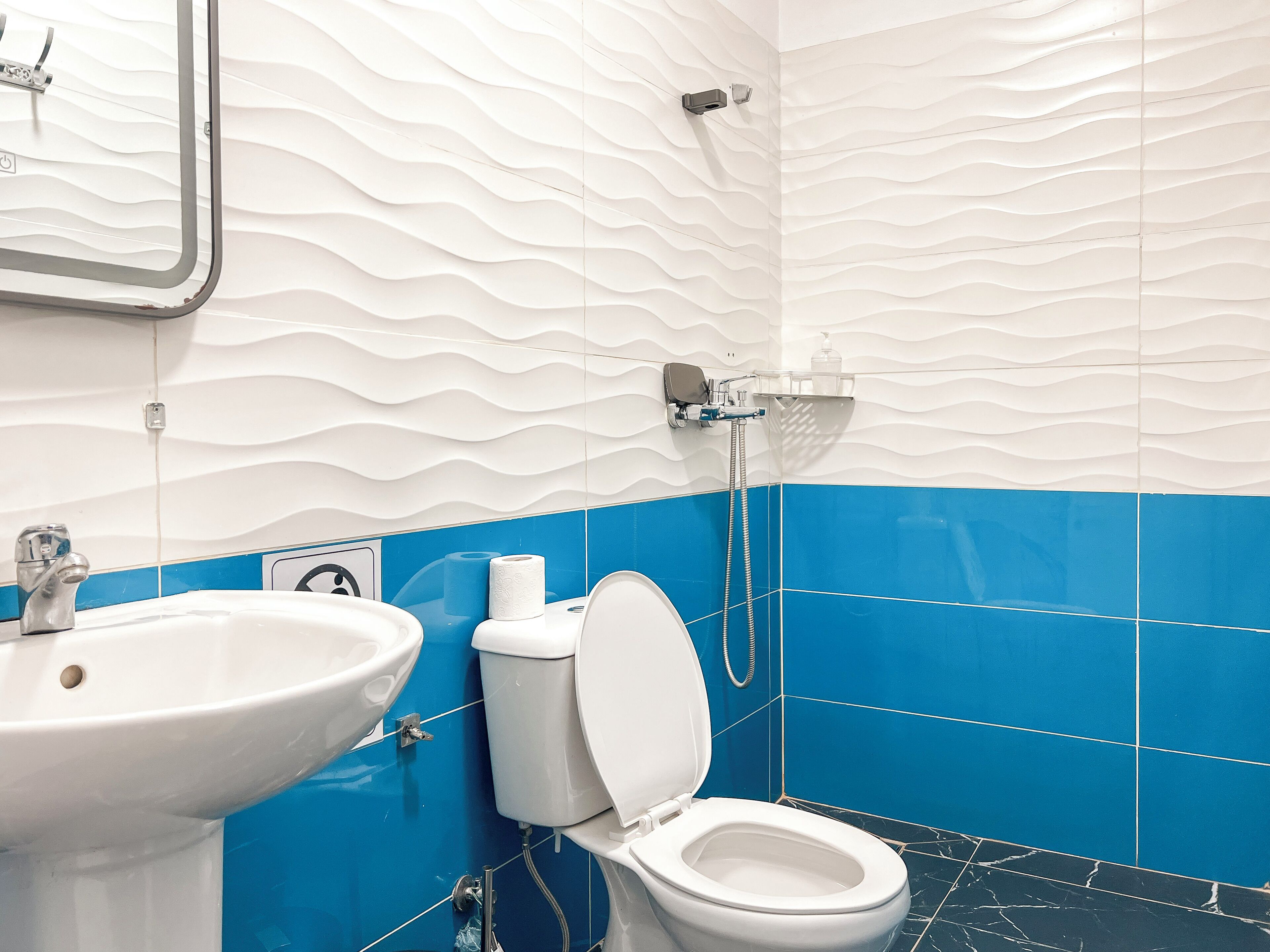 A bathroom with a sink, toilet, and shower.