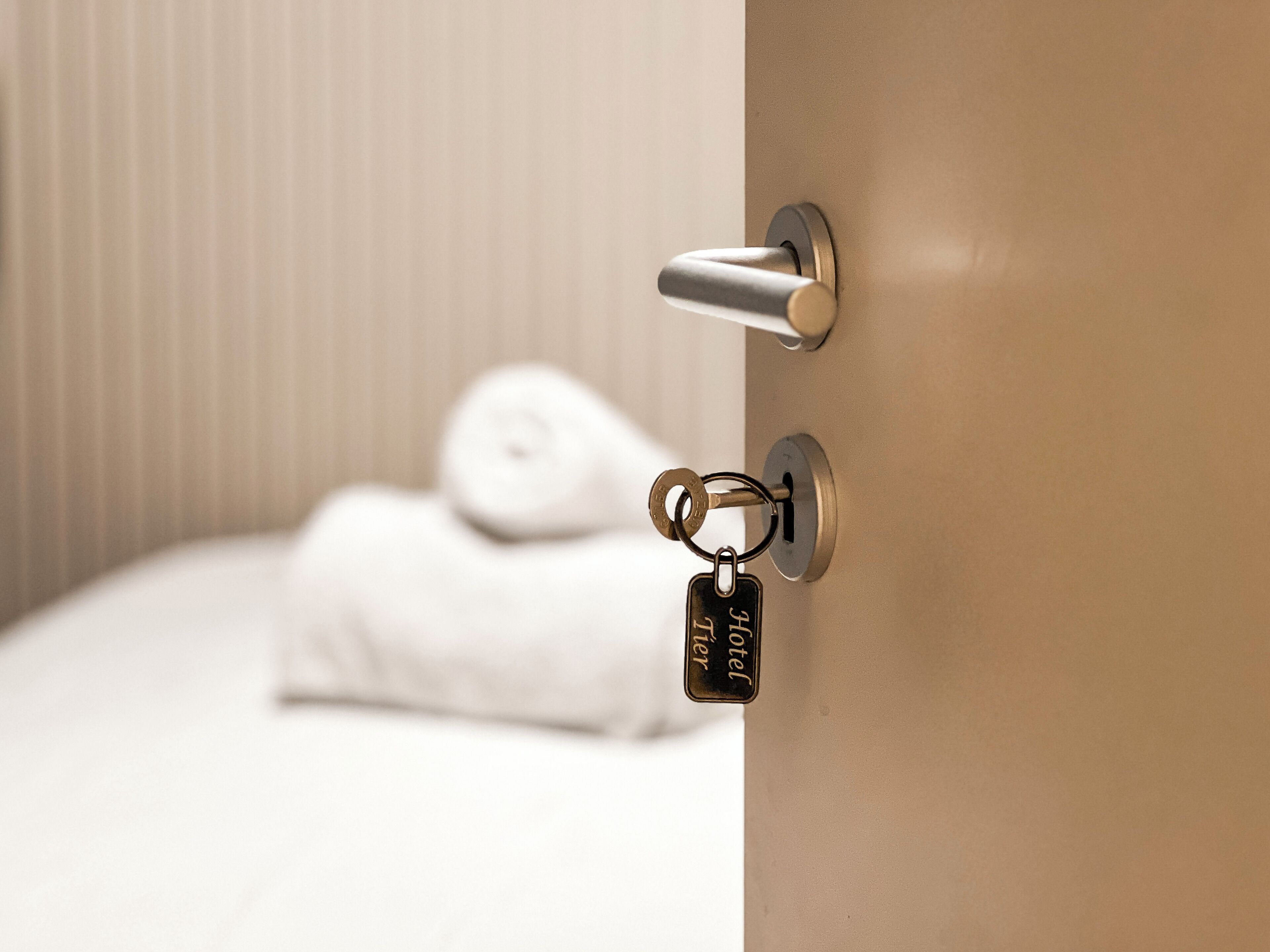 A hotel room door with a keycard lock and a key.