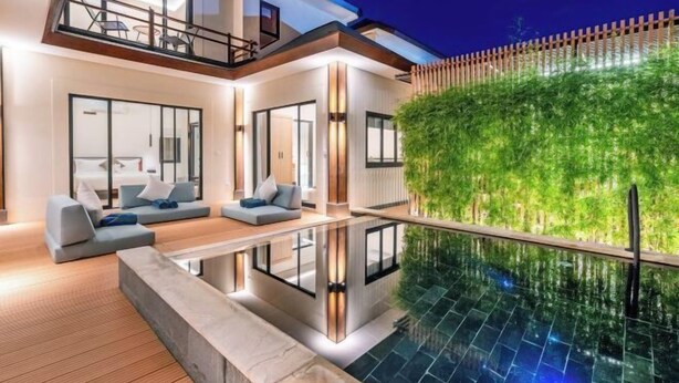 A modern house with a swimming pool, a balcony, and a green wall. - Oasis Residences Sanur – Family-Friendly 3-BR Villa with Private Pool & Garden (Bali)