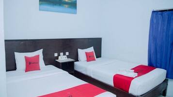 A hotel room with two beds, a nightstand with a phone, and a painting on the wall.