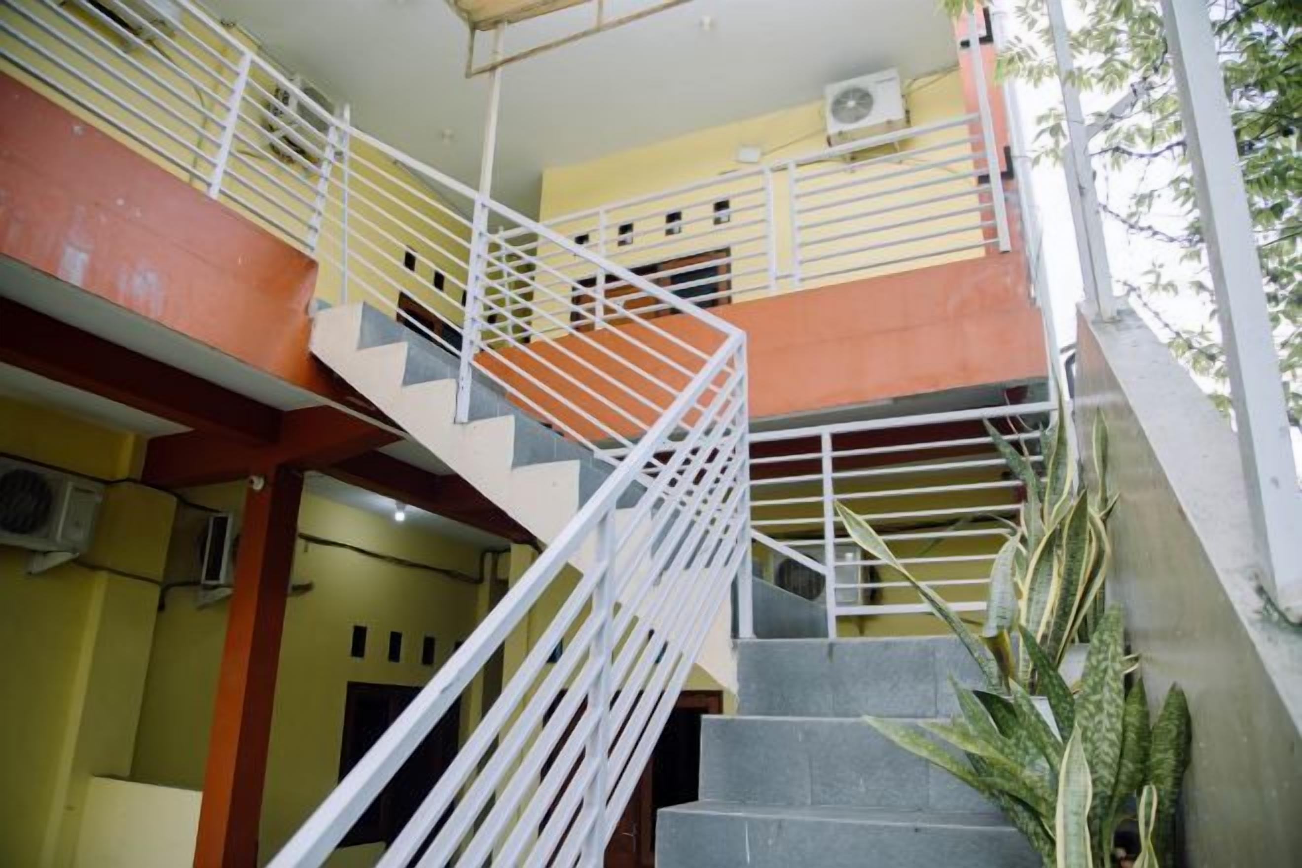 A multi-level staircase with metal railings and a concrete floor.