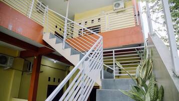 A multi-level staircase with metal railings and a concrete floor.