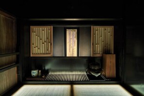 A traditional Japanese room with tatami flooring, sliding doors, and a shoji screen. - KIRAKU KYOTO RINPA (Kyoto)