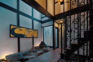 A room with a large window, a painting, and a rock garden. - KIRAKU KYOTO RINPA (Kyoto)