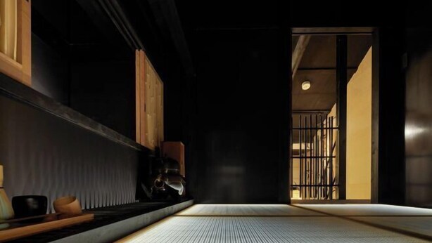 A traditional Japanese room with tatami flooring, sliding doors, and a low wooden table with a tea set. - KIRAKU KYOTO RINPA (Kyoto)