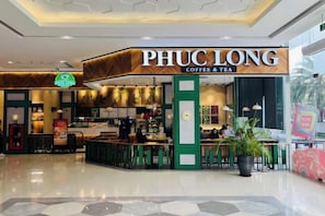 A coffee shop named PHUC LONG with a modern interior and a seating area. - Vinhomes Skylake Residence Hanoi City - Mango Housing (Hanoi)