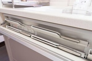 A white countertop with a built-in paper dispenser and a control panel. - 10 Min Walk to Ikebukuro Station 4BR Private House 3 Min to Kanamecho Sleeps 8 (Tokyo)