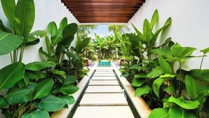 A pathway leading to a pool surrounded by lush greenery. - Villa Ubud Escape by BaliSuperHost (Bali)