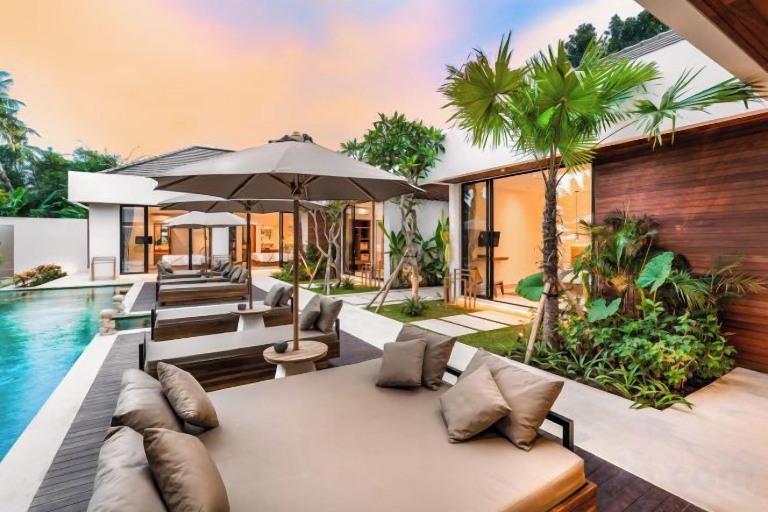 A modern outdoor living area with a pool, lounge seating, and a wooden wall.