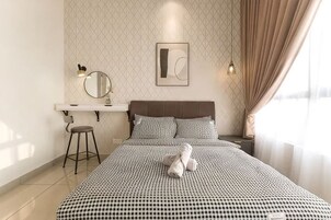 A neatly arranged bedroom with a bed, a bedside table, a mirror, and a window with curtains.
