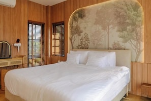 A bedroom with a large bed, wooden paneling, and a wall-mounted headboard. - Tierra en Sierra (Pak Chong)
