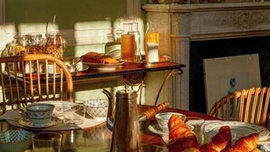 A breakfast table with croissants, a coffee pot, and various glass containers. - Huberdière Castle (Nazelles-Negron)