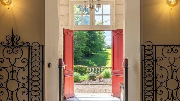 A doorway with open red shutters leading to a garden. - Huberdière Castle (Nazelles-Negron)
