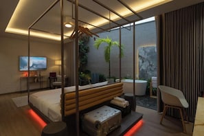 A modern bedroom with a glass-enclosed bed, a bathtub, and a view of a garden.