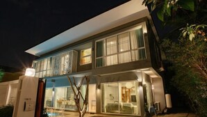 A modern two-story building with large windows and a pool area visible at the front. - Private Pool Villa 6 Bedroom - Cloud Nine Villa (Chiang Mai)